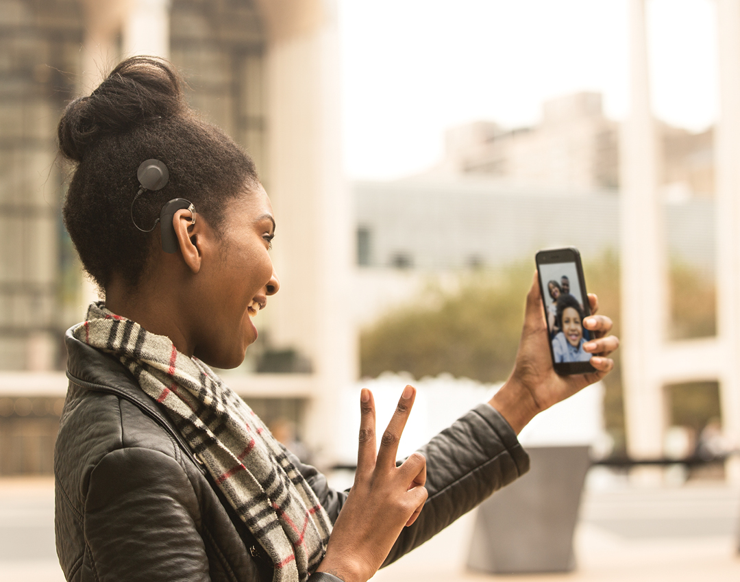 woman talking to a person on phone giving the peace sign